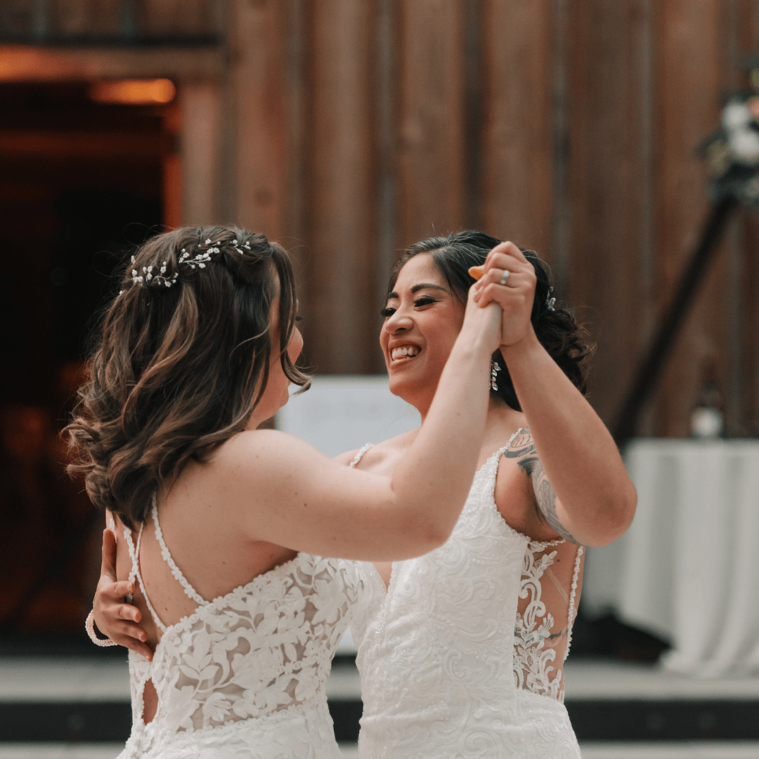 PNW Wedding Dance - PNW Weddings - Choreographer Entertainment - Oregon Washington Idaho - LGBTQ Two Brides Updo Flower Crown Appliqué Lace Dress Crystal Earrings Dancing-min PDX Flash Mob