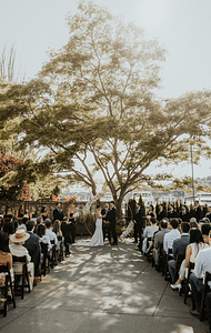 Emett Joseph Photography - PNW Weddings - Photographer - Oregon Washington - Tree Flower Arch Marina Vows Wooden Chairs Golden Hour-min
