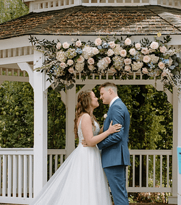 Flowers By Alana - PNW Weddings - Florist - Oregon Washington - Floral Arch Gazebo Boutonniere Babysbreath Roses Pastel Hydrangea Blue Suit Garden-min