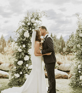 Flowers By Alana - PNW Weddings - Florist - Oregon Washington - White Hydrangea Flower Arch Kiss Grey Suit Mountains Veil Mermaid Dress Boutonniere-min