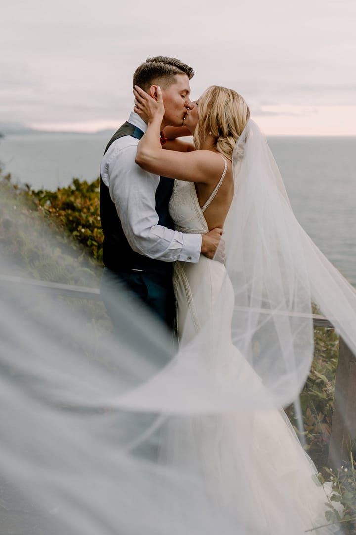Birman Visuals Oceanside Wedding Couple Kissing Long Veil PNW Weddings Birman Visuals Oceanside Wedding Couple Kissing Long Veil PNW Weddings